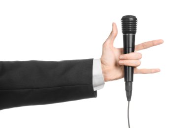 İş ve konuşma konu: izole Studio beyaz arka plan üzerinde siyah bir mikrofon tutan siyah elbiseli adam
