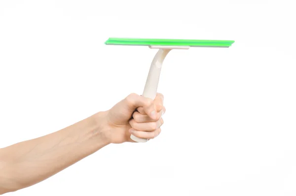 Household cleaning and washing windows theme: man's hand holding a green scraper windows isolated on a white background in the studio. — Stok fotoğraf