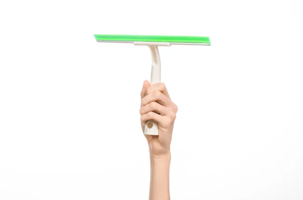 Household cleaning and washing windows theme: man's hand holding a green scraper windows isolated on a white background in the studio. — Stock Photo, Image