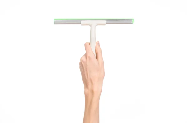 Household cleaning and washing windows theme: man's hand holding a green scraper windows isolated on a white background in the studio. — Stock Fotó