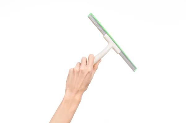 Household cleaning and washing windows theme: man's hand holding a green scraper windows isolated on a white background in the studio. — Stock Photo, Image