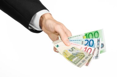 Money and business topic: hand in a black suit holding banknotes 5,10,20 and 100 euro on white isolated background in studio