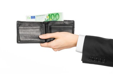 Money and business topic: hand in a black suit holding a wallet with 100 euro banknotes isolated on white background in studio