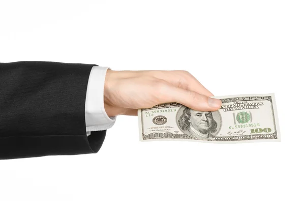 Geld und Geschäftsthema: Hand in schwarzem Anzug mit einem 100-Dollar-Schein auf weißem Hintergrund im Studio — Stockfoto