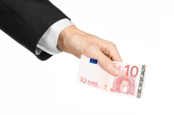 Money and business topic: hand in a black suit holding a banknote 10 euro isolated on a white background in studio Stock Photo