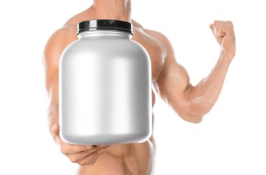 Bodybuilding and Sports theme: handsome strong bodybuilder holding a plastic jar with a dry protein and showing gesture isolated on white background in studio