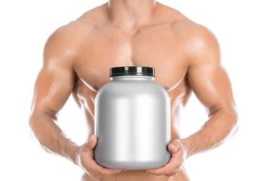 Bodybuilding and Sports theme: handsome strong bodybuilder holding a plastic jar with a dry protein and showing gesture isolated on white background in studio