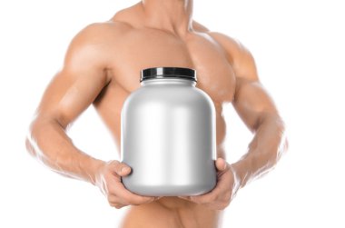 Bodybuilding and Sports theme: handsome strong bodybuilder holding a plastic jar with a dry protein and showing gesture isolated on white background in studio