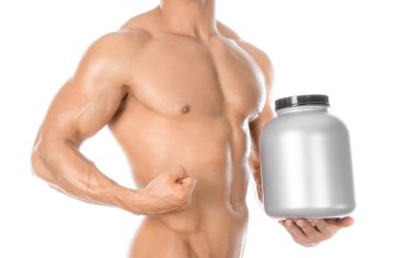 Bodybuilding and Sports theme: handsome strong bodybuilder holding a plastic jar with a dry protein and showing gesture isolated on white background in studio
