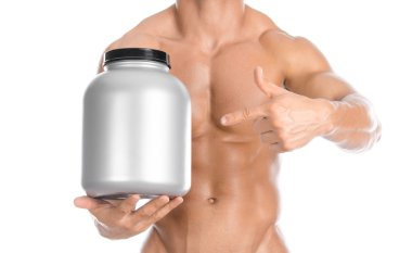 Bodybuilding and Sports theme: handsome strong bodybuilder holding a plastic jar with a dry protein and showing gesture isolated on white background in studio