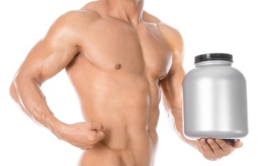 Bodybuilding and Sports theme: handsome strong bodybuilder holding a plastic jar with a dry protein and showing gesture isolated on white background in studio