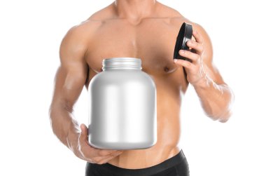 Bodybuilding and Sports theme: handsome strong bodybuilder holding a plastic jar with a dry protein and showing gesture isolated on white background in studio