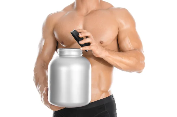 Bodybuilding and Sports theme: handsome strong bodybuilder holding a plastic jar with a dry protein and showing gesture isolated on white background in studio — Zdjęcie stockowe