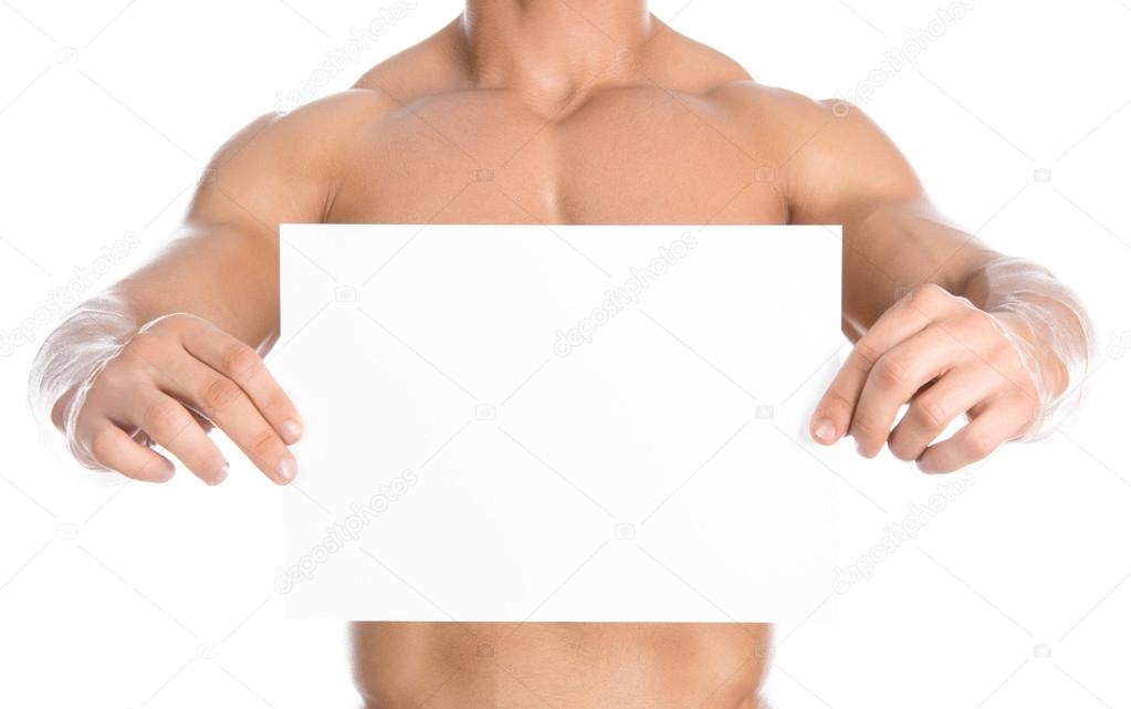 Bodybuilding and advertising: a nice strong bodybuilder holding a paper white blank card isolated on white background in studio