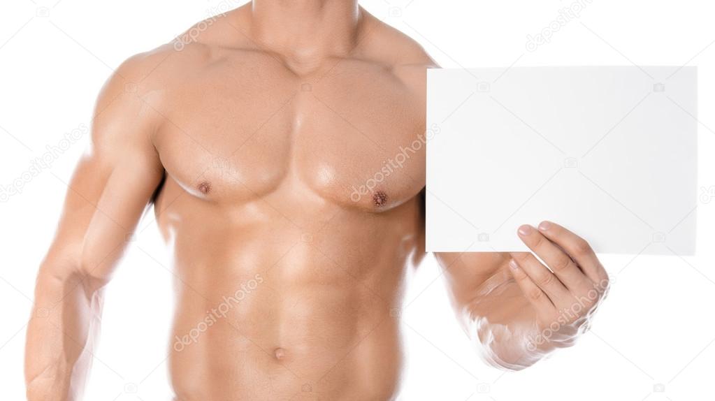 Bodybuilding and advertising: a nice strong bodybuilder holding a paper white blank card isolated on white background in studio