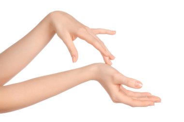 Beauty and Health theme: beautiful elegant female hand isolated on a white background in the studio, using cream advertisement, massage