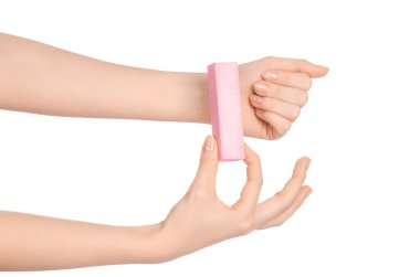 Health and hand care topic: a woman's hand holding a nail file for manicure isolated on white background in studio