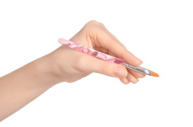 Beauty and makeup topic: a woman's hand holding a brush makeup isolated on white background in studio