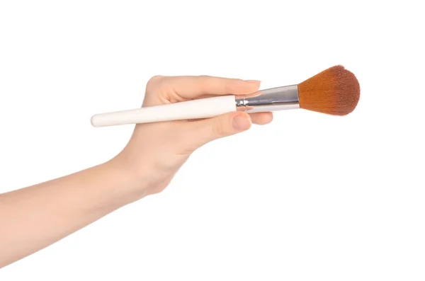 Makeup and beauty topic: a woman's hand holding a brush makeup isolated on white background in studio — Stockfoto