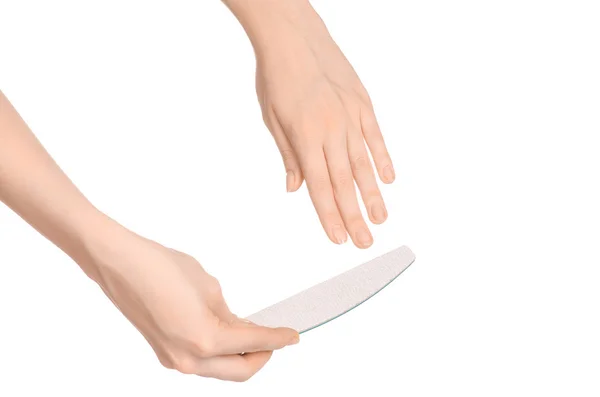 Health and hand care topic: a woman's hand holding a nail file for manicure isolated on white background in studio — Stockfoto