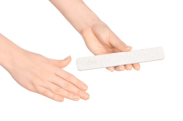 Health and hand care topic: a woman's hand holding a nail file for manicure isolated on white background in studio — 图库照片