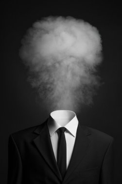 Surrealism and business topic: the smoke instead of a head man in a black suit on a dark background in the studio clipart