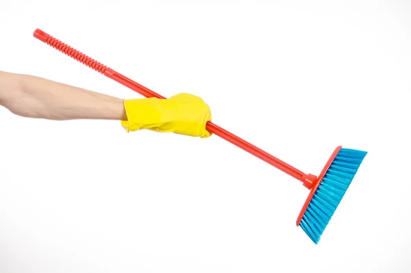 Cleaning the house topic: human hand in yellow rubber gloves holding a red broom isolated on a white background in studio — Stock Photo, Image