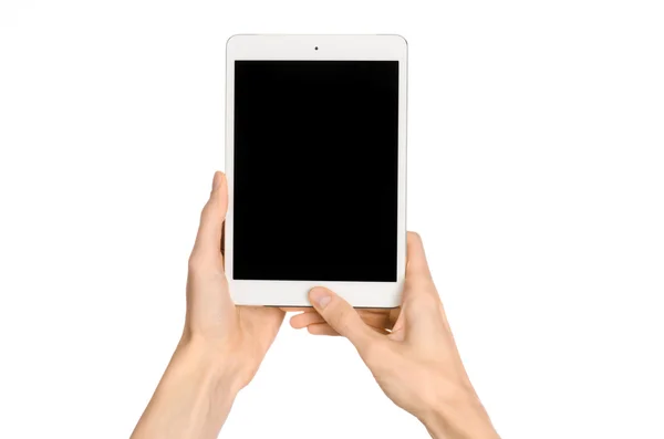 Presentation and advertising touchscreen topic: human hand holding a white tablet touch computer gadget with touch blank black screen isolated on a white background in the studio, first-person view — 스톡 사진