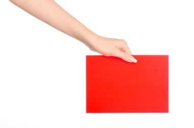 Branding and advertising theme: beautiful female hand holding a blank red paper card isolated on white background