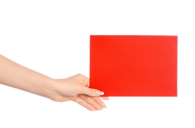 Branding and advertising theme: beautiful female hand holding a blank red paper card isolated on white background