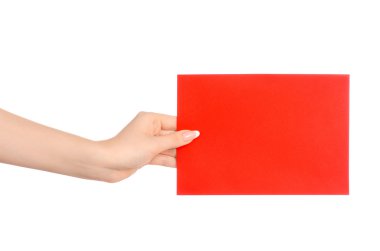 Branding and advertising theme: beautiful female hand holding a blank red paper card isolated on white background