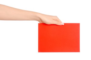 Branding and advertising theme: beautiful female hand holding a blank red paper card isolated on white background