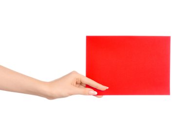 Branding and advertising theme: beautiful female hand holding a blank red paper card isolated on white background