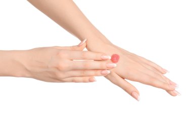 Health and body care theme: beautiful female hand with pink scrub cream on a white background isolated clipart
