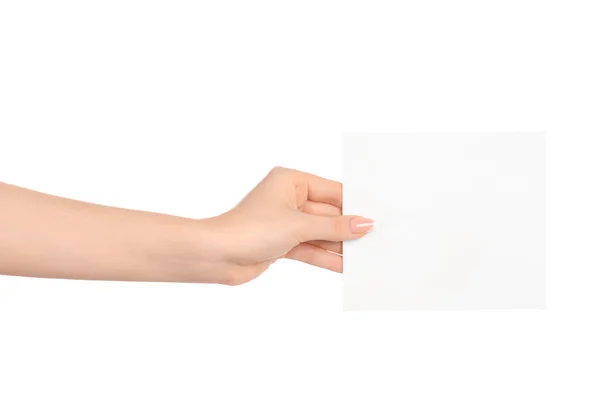 Značky a reklamní téma: krásná ženská ruka drží prázdný dokument white paper kartu izolovaných na bílém pozadí — Stock fotografie