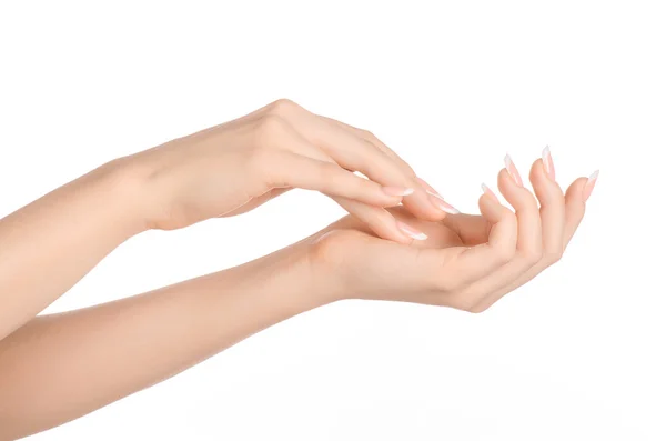 Téma péče o tělo a zdraví: krásné ženské ruky s bílým krémem izolovaných na bílém pozadí, masáž rukou — Stock fotografie