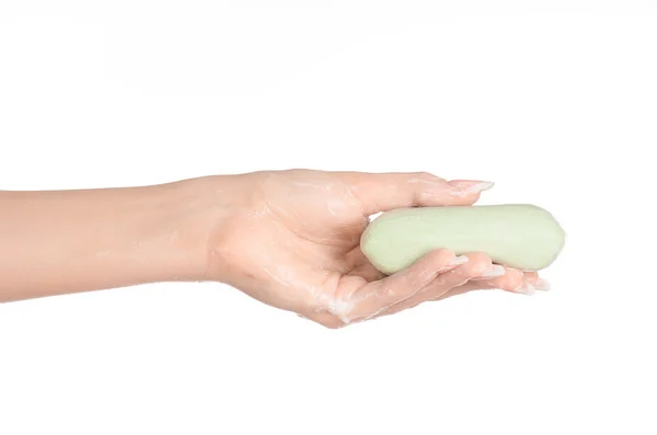 Thema Hygiene und Gesundheitsfürsorge: Die Hand einer Frau hält einen grünen Streifen Seife isoliert auf weißem Hintergrund im Studio — Stockfoto