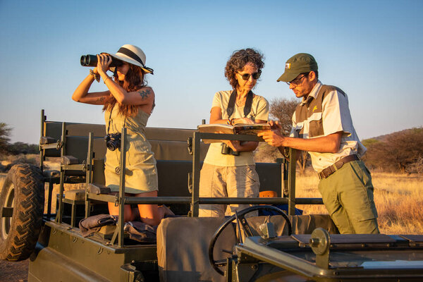 Guide and two female guests discuss sighting