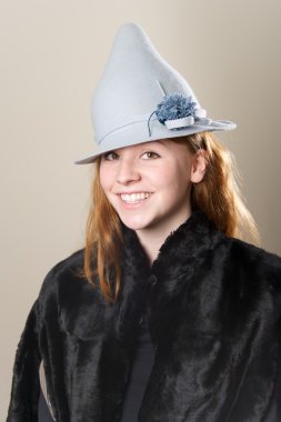 Kızıl saçlı mavi şapka ve kürk gülümseyen