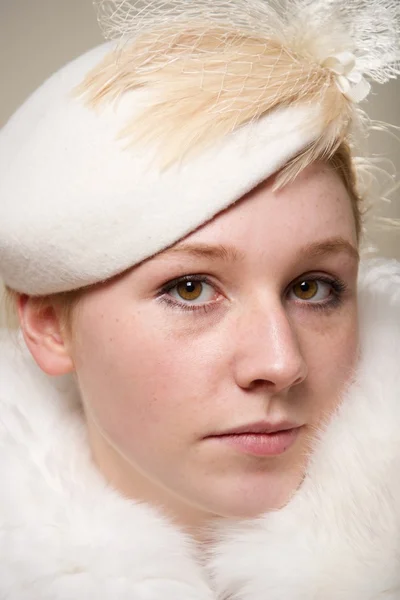 Close-up of serious redhead in cream hat — Stock Photo, Image