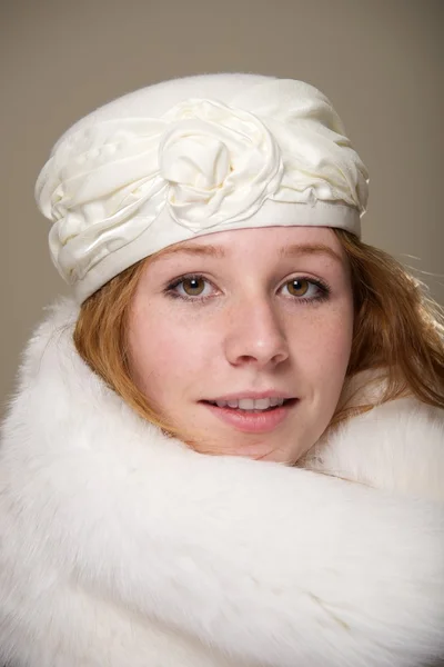 Redhead in cream hat and white fur — Stock Photo, Image
