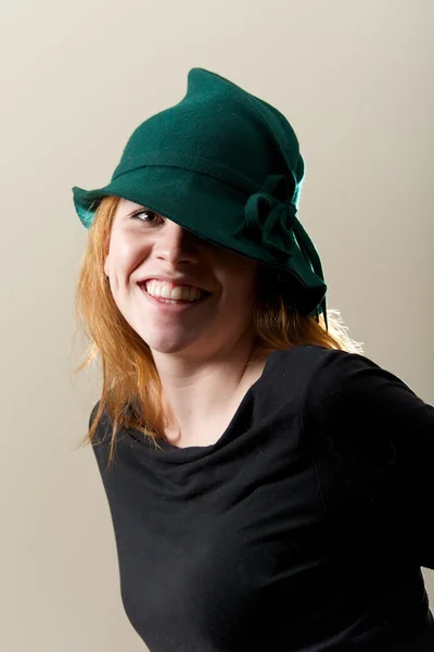 Redhead in green hat and black top — Stock Photo, Image