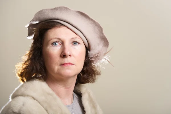 Serious brunette in taupe hat and fur — Stock Photo, Image