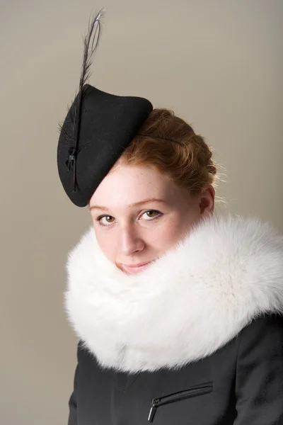 Smiling redhead in black hat and fur — Stock Photo, Image