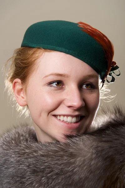 Smiling redhead in green hat looking up — Stock Photo, Image