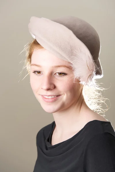 Smiling redhead in taupe hat looking down — Stock Photo, Image