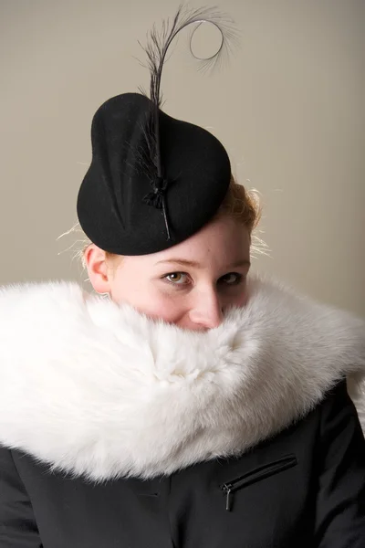 Smiling redhead with mouth hidden by fur — Stock Photo, Image