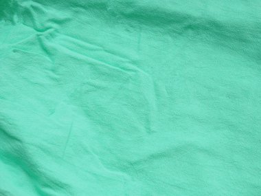 Pamuk kumaşın arkaplan dokusu açık yeşil renk. Metnin ve tasarımın için uzayı kopyala. Tekstil konsepti ve yumuşak fon, düz la