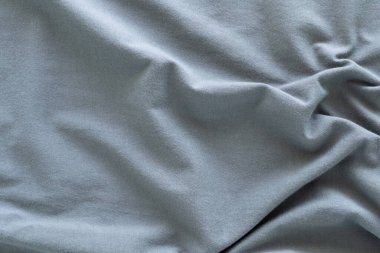Dalgalı koyu gri pamuk kumaş. Güzel pürüzsüz, zarif, soyut arkaplan tasarımı.