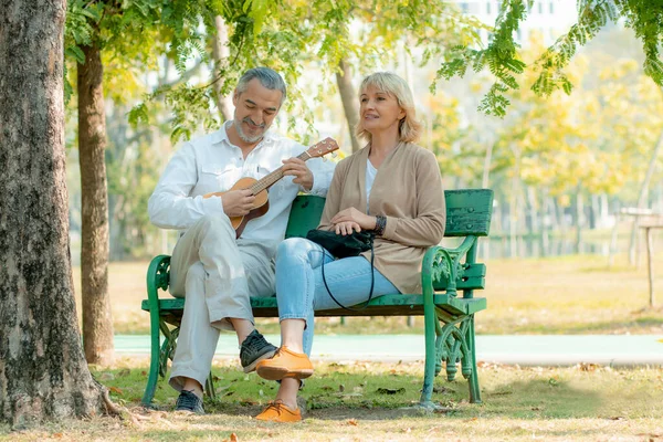 Happy elder love couple in romance sitting and playing